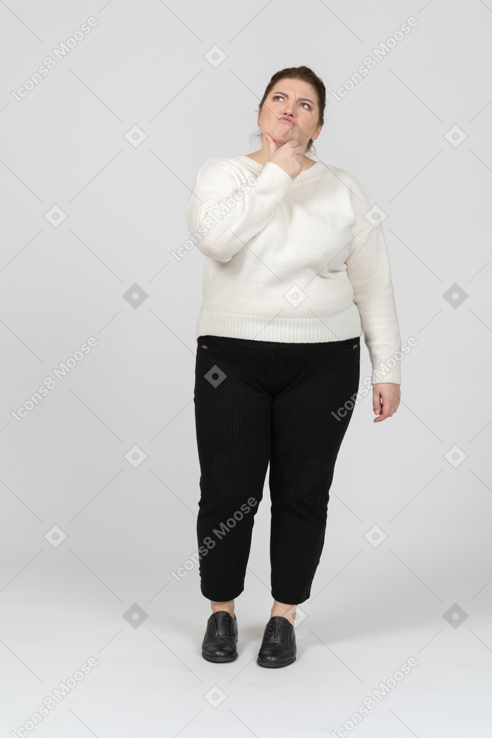 Front view of a plus size woman in casual clothes thinking