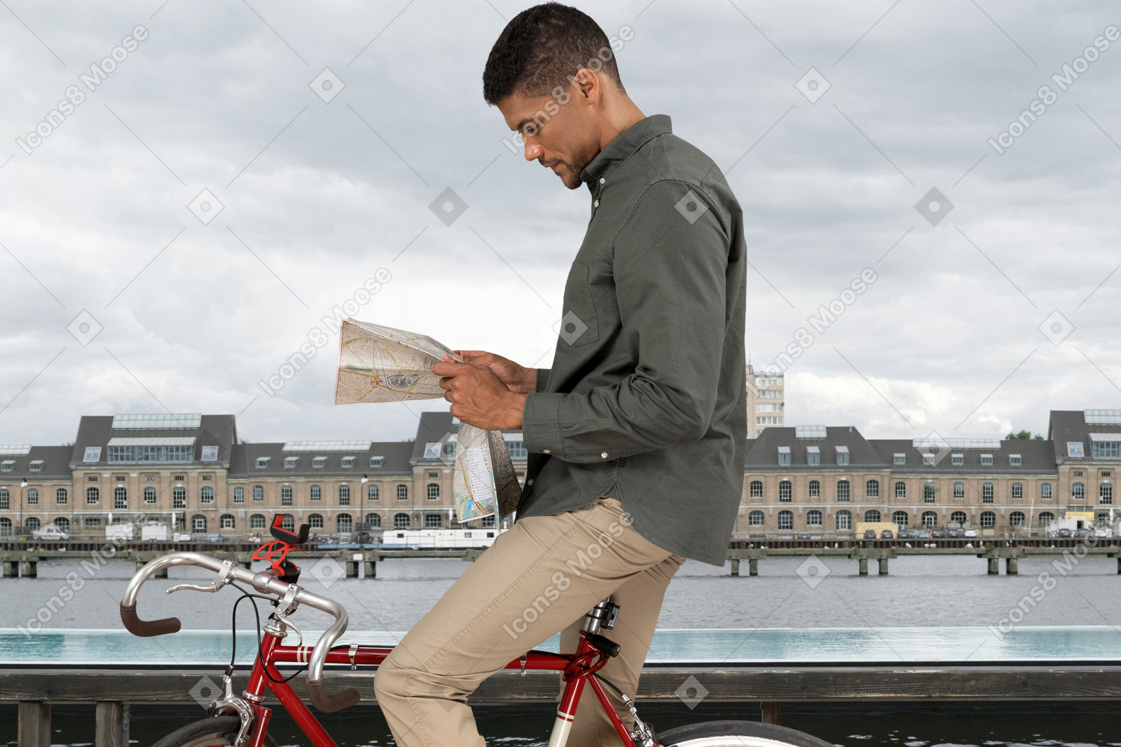 Man looking at map while standing on a bike