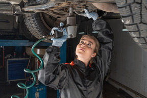 Young woman repairing car