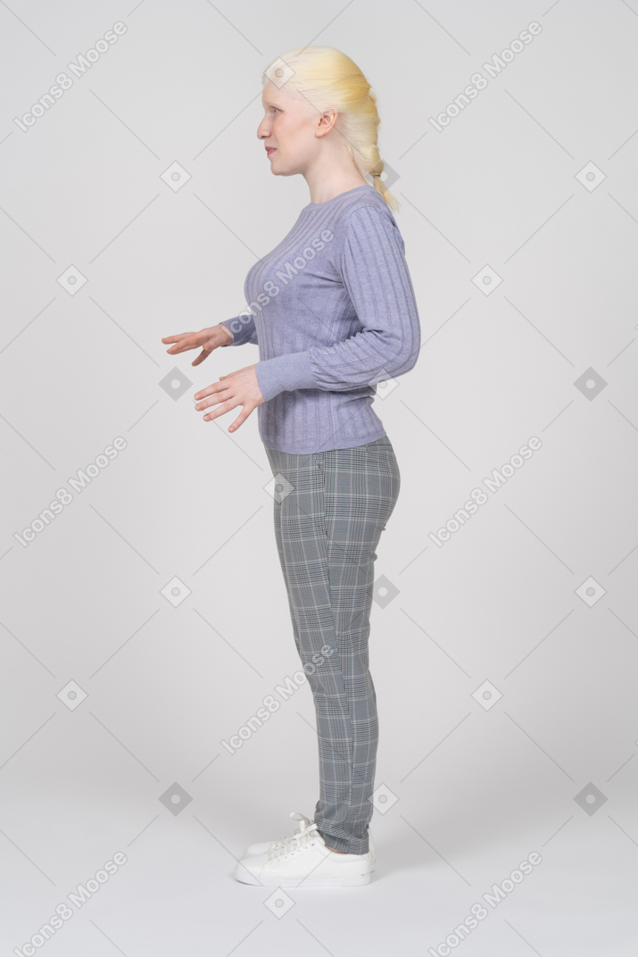 Side view of young woman with arms bent