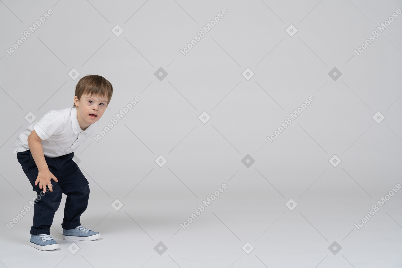 Surprised little boy standing with bent knees
