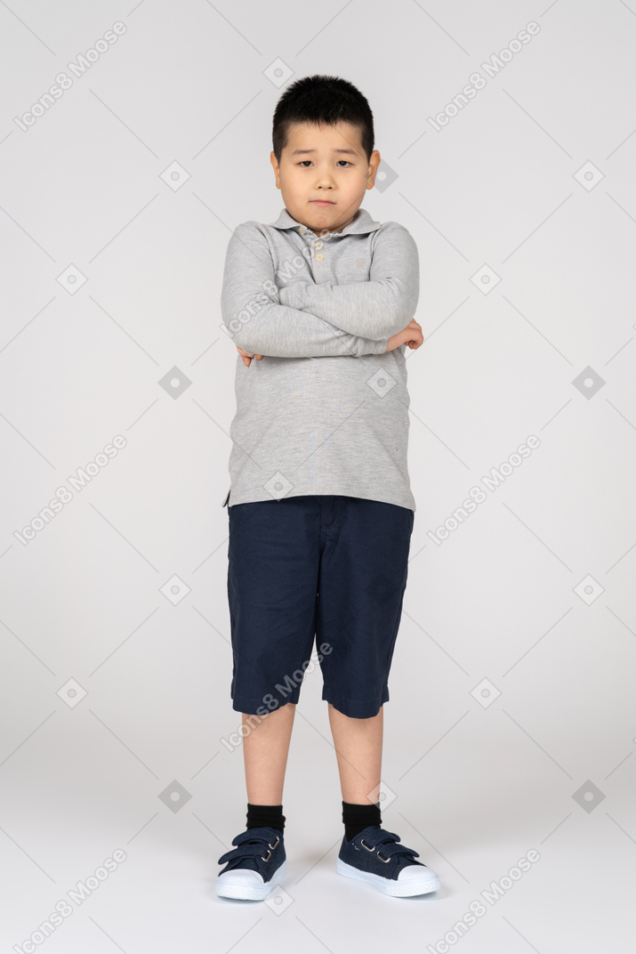 Boy looking at camera with his arms crossed