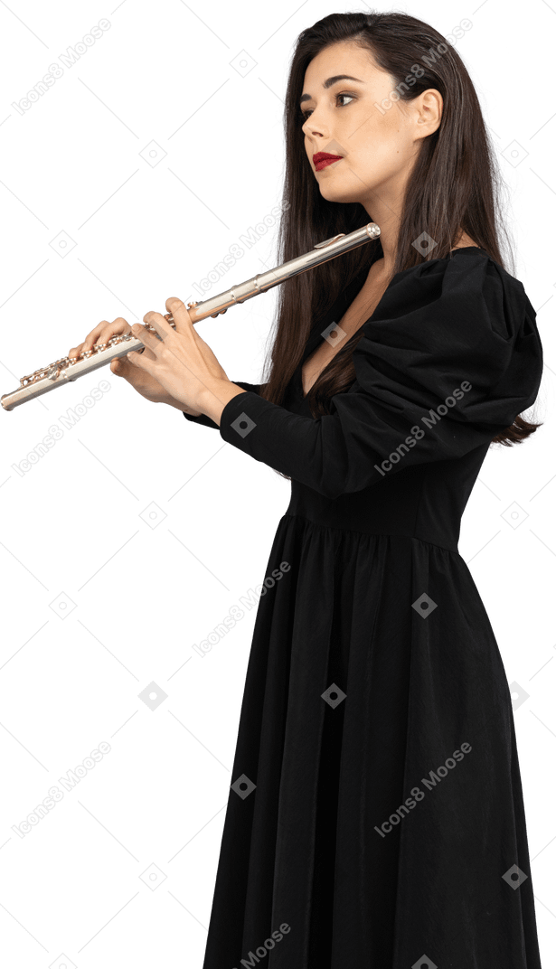 Side view of a serious young lady in black dress holding flute