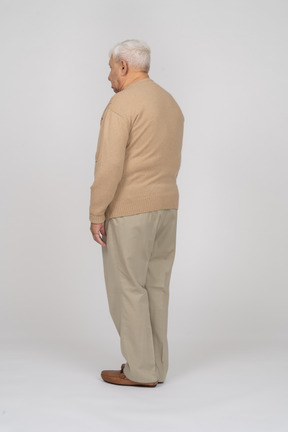 Side view of an old man un casual clothes standing still