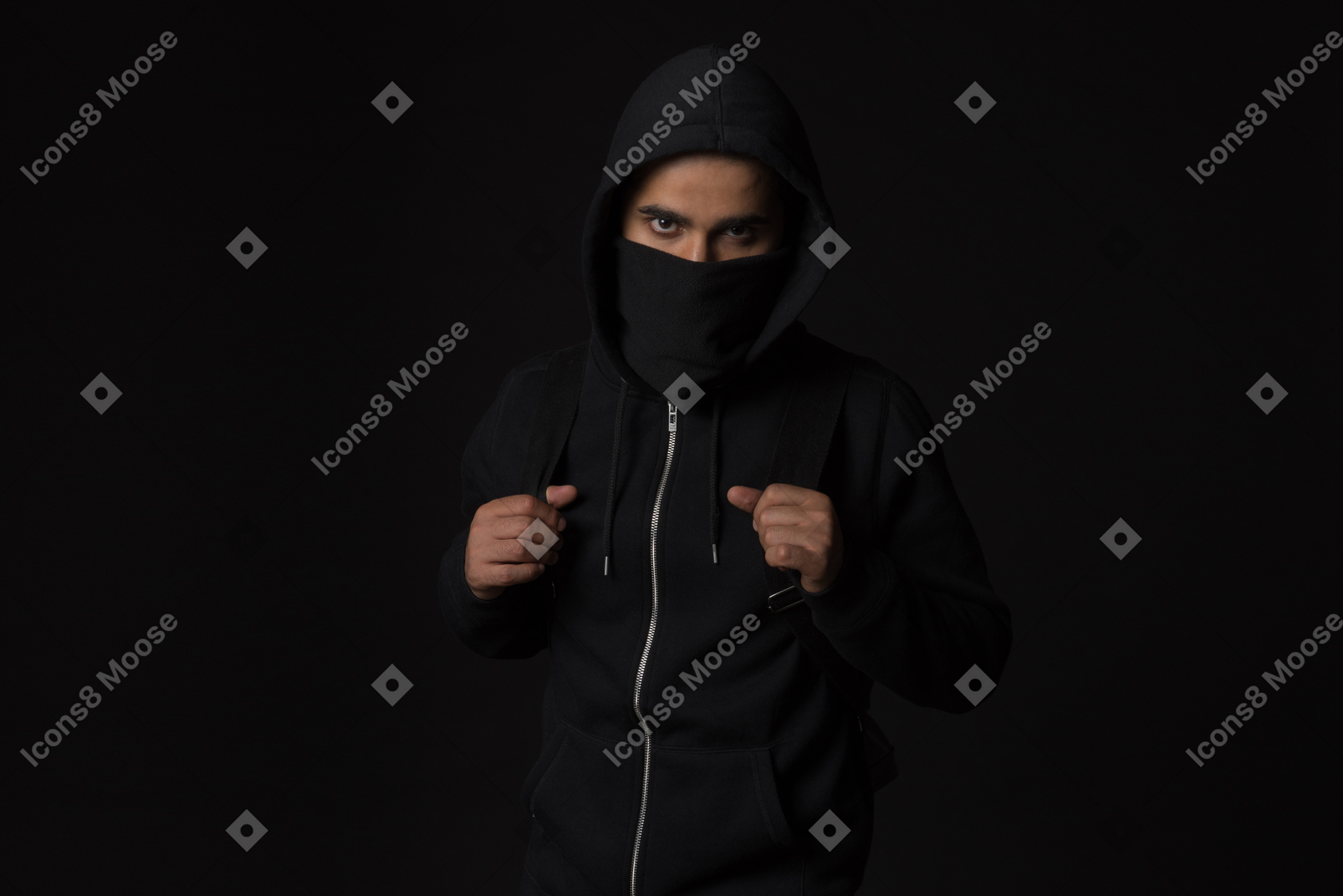 Hacker guy with covered face standing in the dark