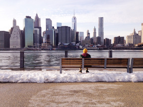 Man sitting on a bench and enjoying city view
