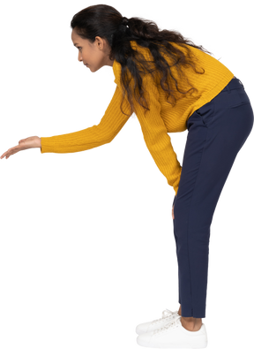 Side view of a girl in casual clothes bending down and explaining something