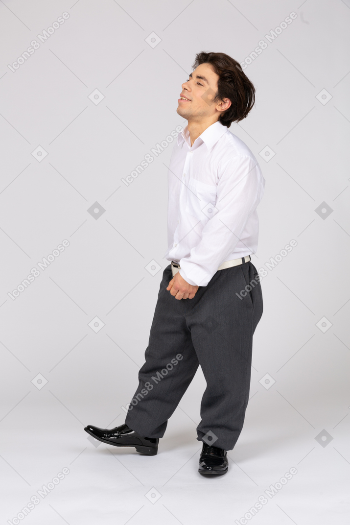 Three-quarter view of a contented man in business casual clothes