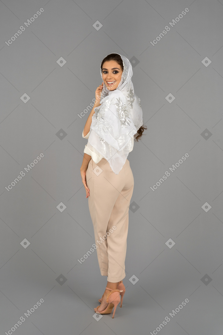 Beautiful arab woman looking back and smiling