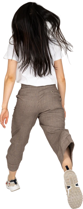 Three-quarter view of a jumping young lady in breeches and t-shirt outspreading her legs