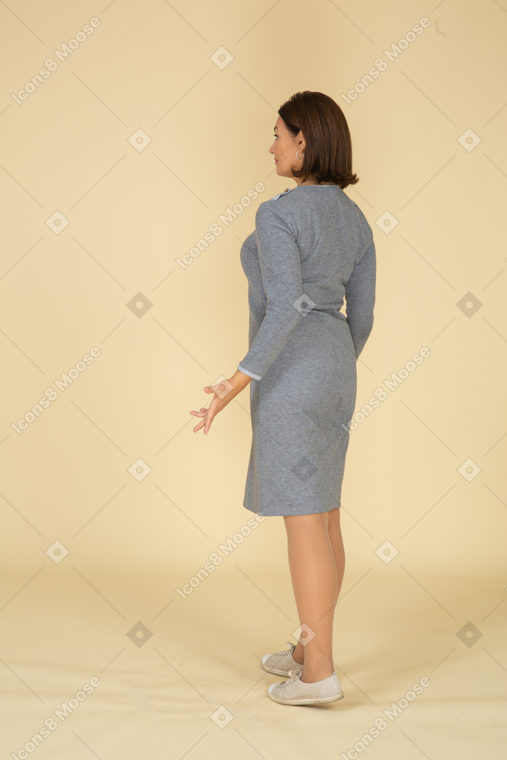 Rear view of a woman in grey dress