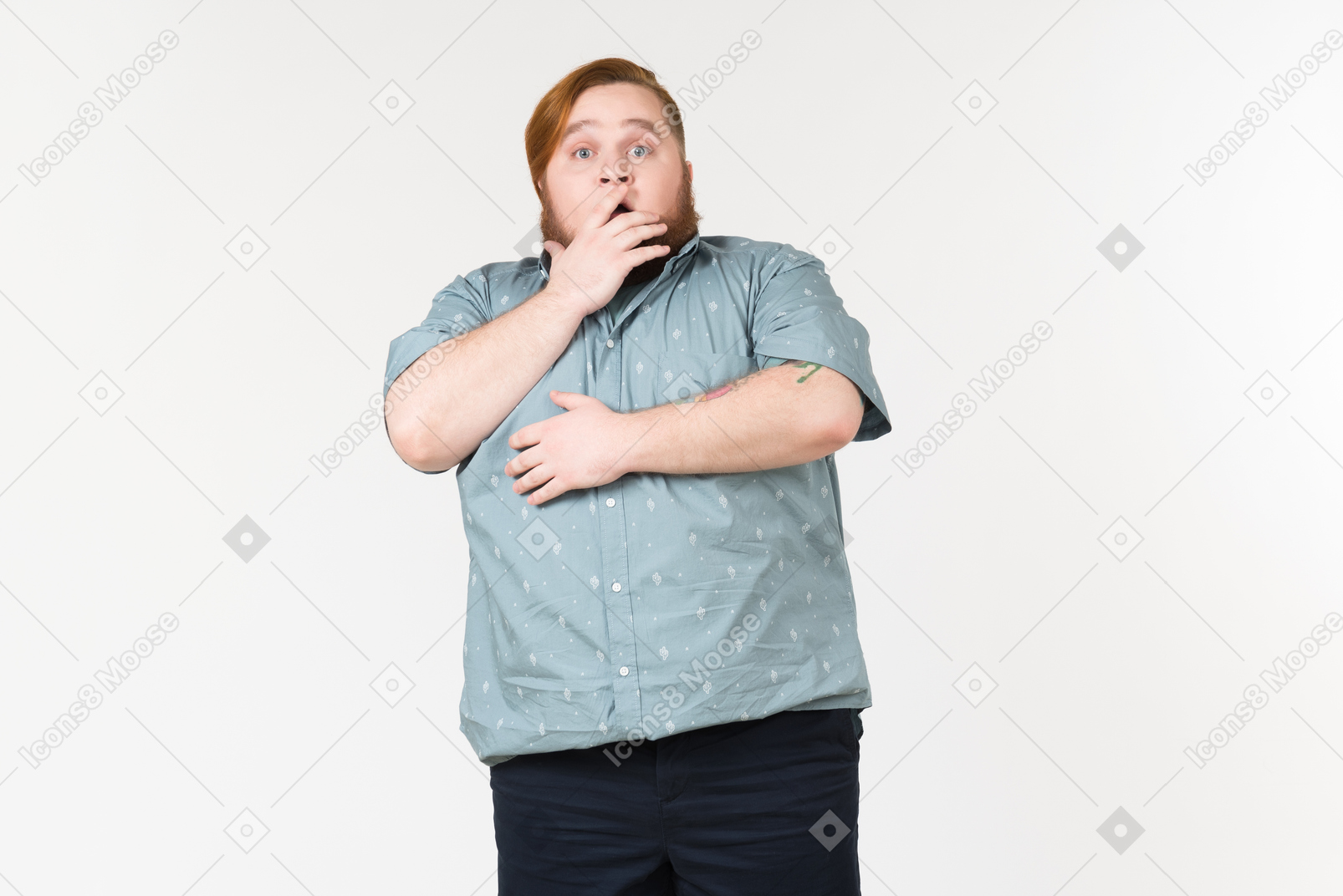 Shocked young overweight man touching his face