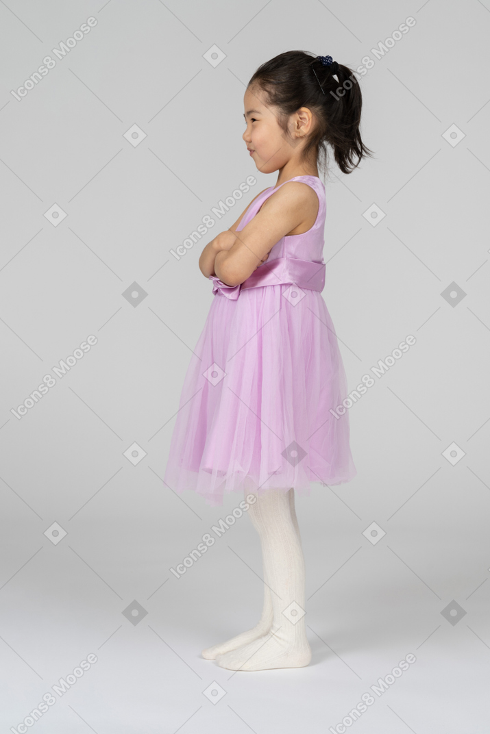 Little girl in pink dress being moody