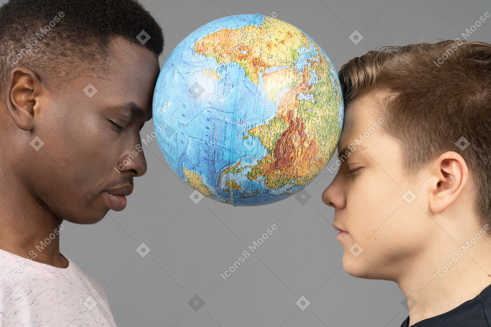 Two young men holding the earth globe between their foreheads