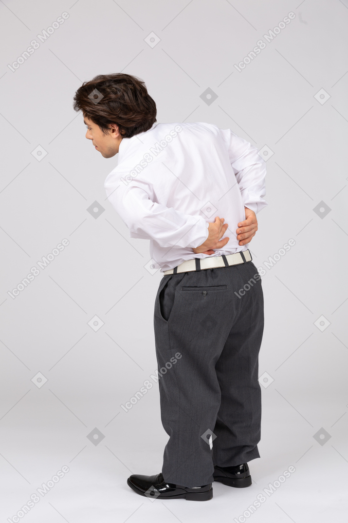 Rear view of man suffering from pain in the back