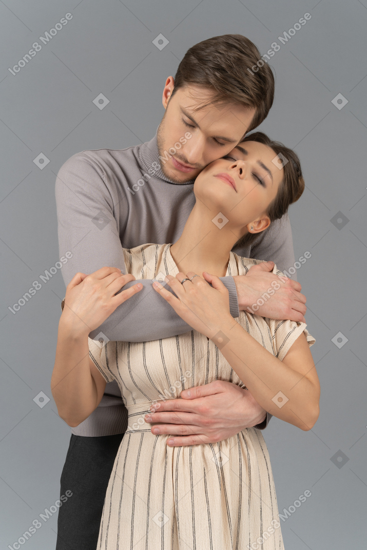 Young couple with their arms wrapped around each other