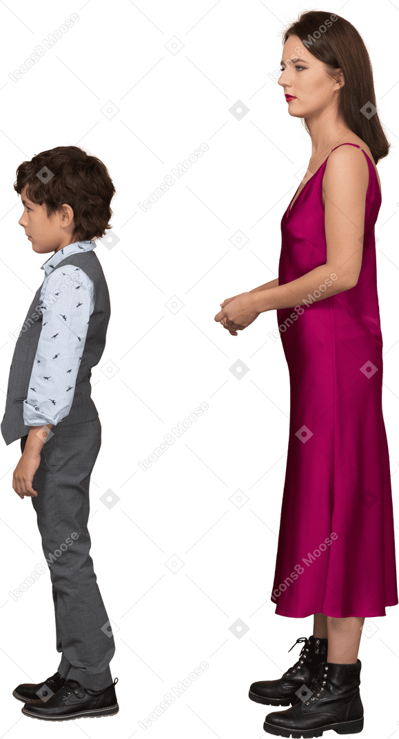 Young woman in dress standing and holding her hand with boy