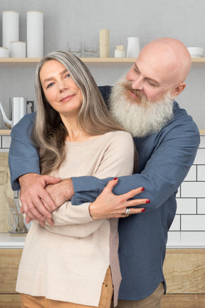 A man hugging a woman in a kitchen