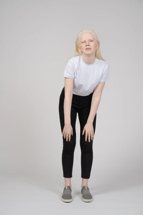 Young woman bending forward with hands on knees