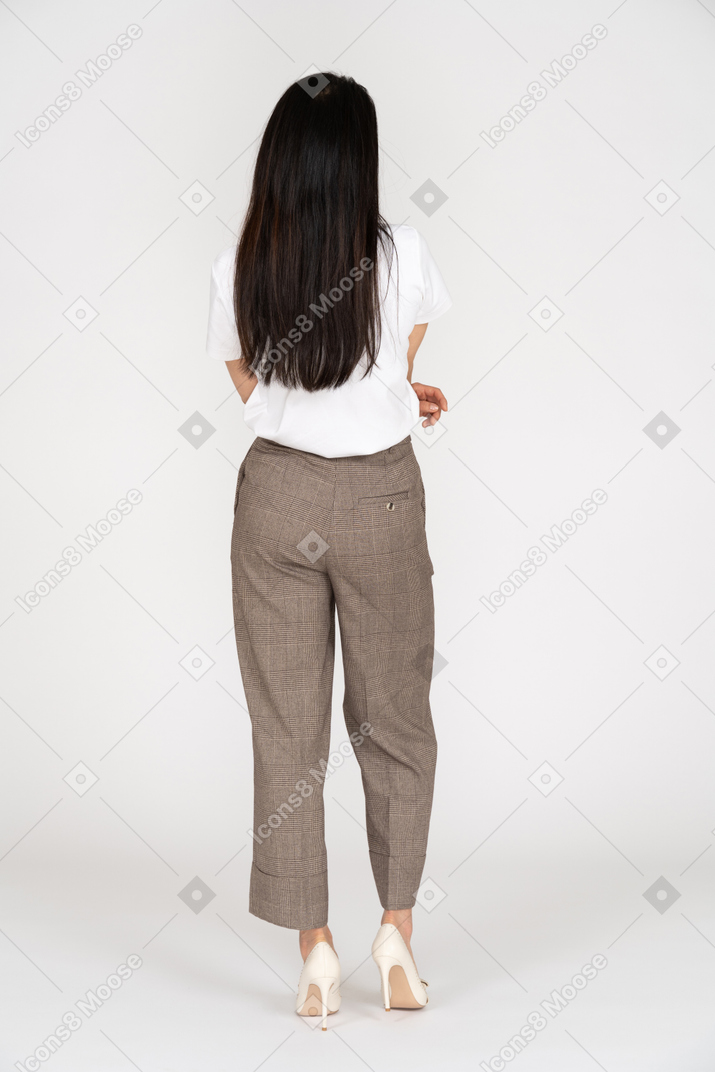 Back view of a young lady in breeches and t-shirt crossing hands