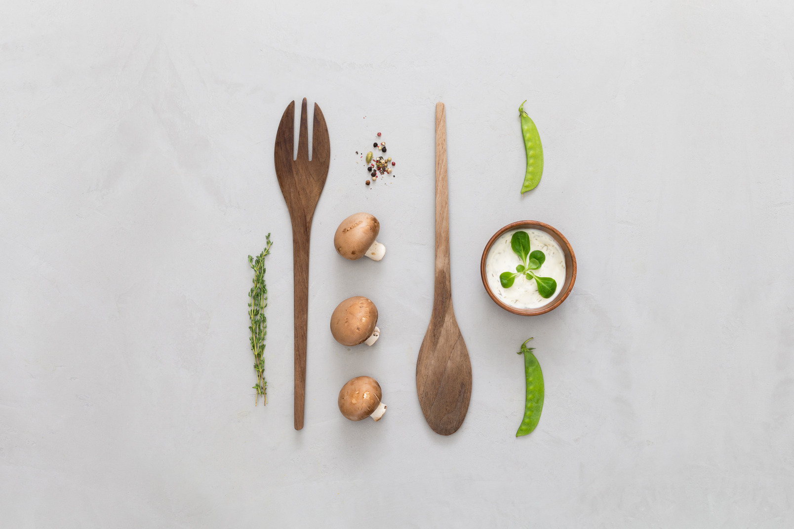 Mushrooms, greens, spices and wooden cutlery