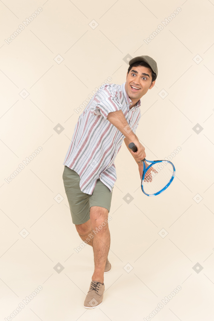Young caucasian man holding tennis racket