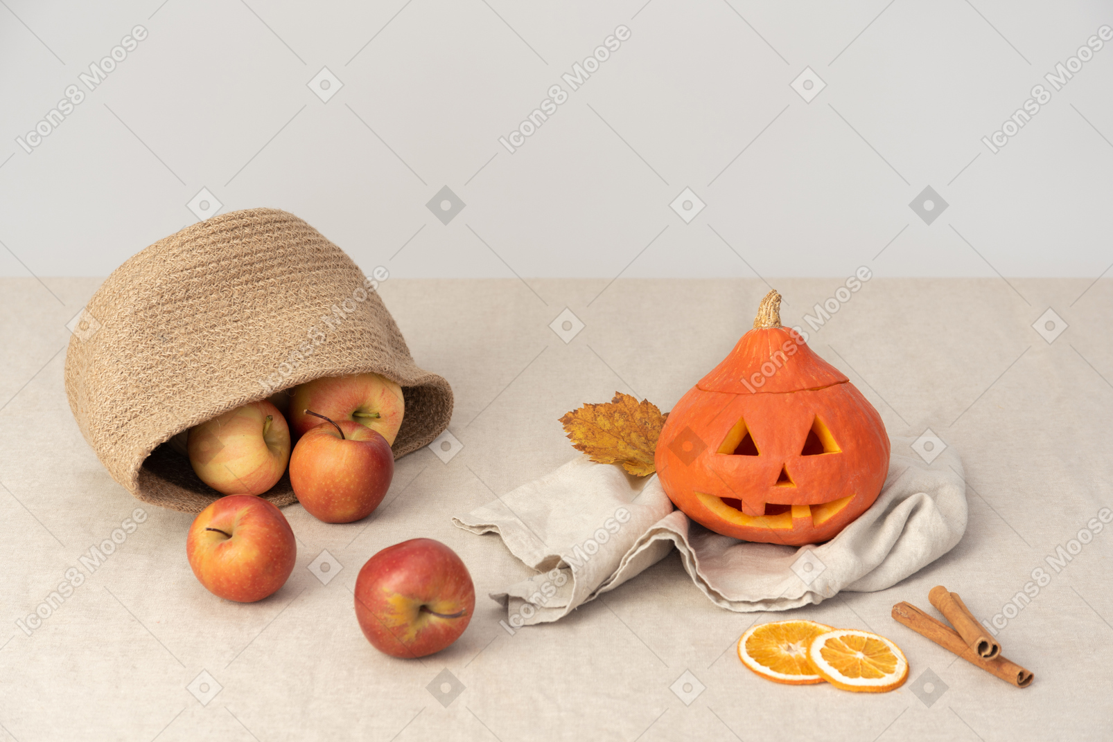 Apples in basket, pumpkin, orange slices and cinnamon sticks