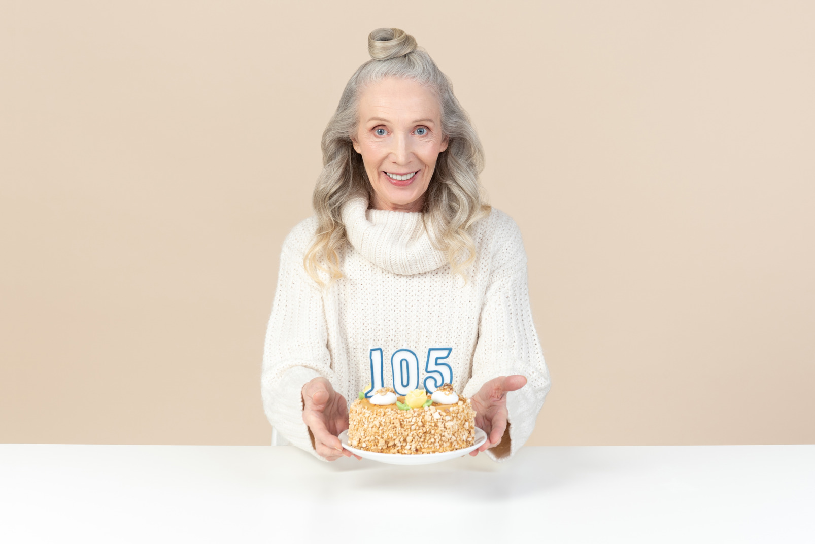 Old woman holding cake for hundred and fifth birthday
