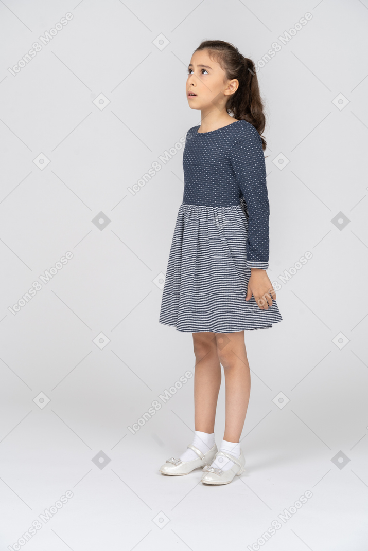 Three-quarter view of a girl looking up anxiously