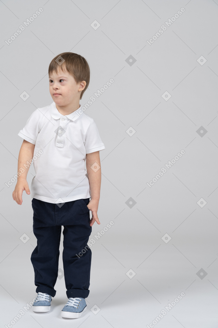 Front view of little boy standing and looking left