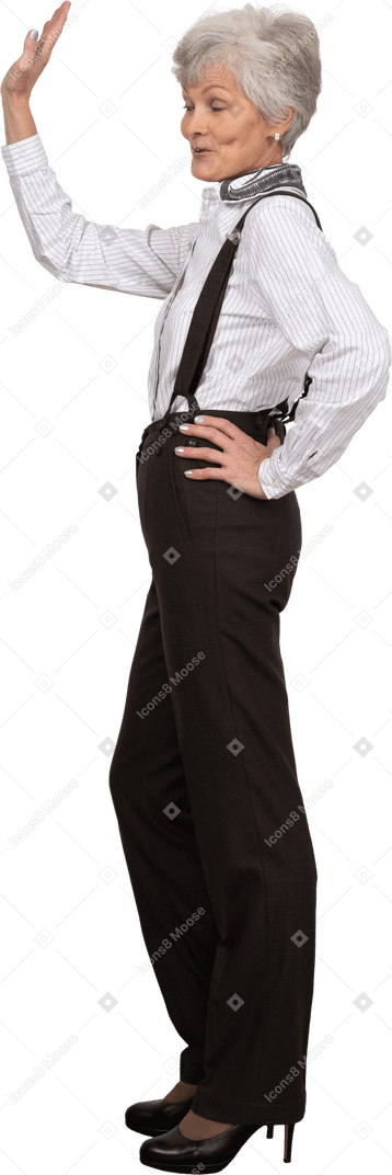 Side view of an old greeting lady in office clothing