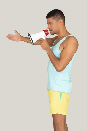 Side view of a lifeguard speaking into a megaphone