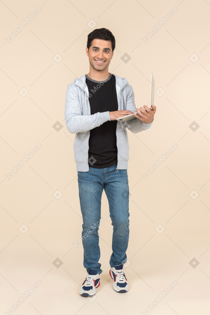 Young caucasian man holding laptop