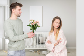 A man giving a woman a bouquet of flowers