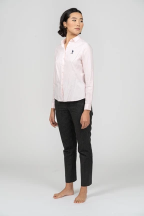 Woman in office clothes standing with head turned