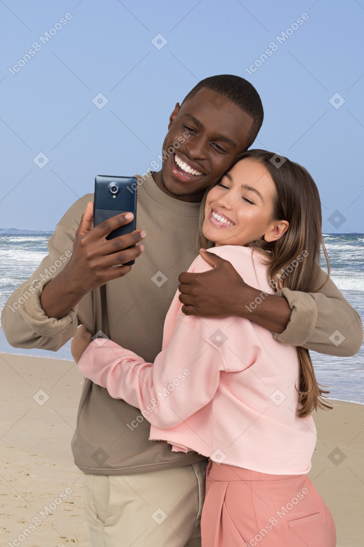 Person and his daughter are photographed on the beach