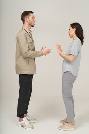 Side view of young couple speaking to each other