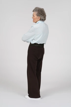 Side view of an old woman frowning with folded hands