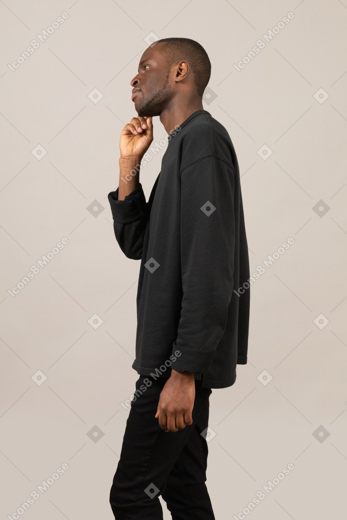 Side view of a young man thinking
