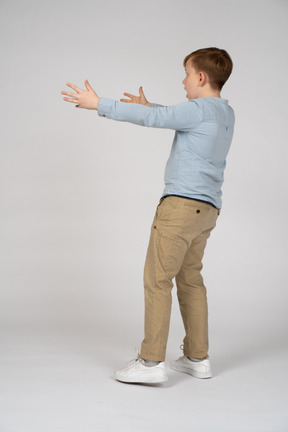 Side view of a boy with stretched arms