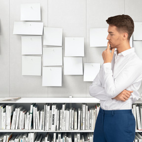 A man standing in front of a book shelf