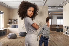 Two children standing in a room with wooden floors