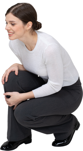 Front view of a happy woman squatting