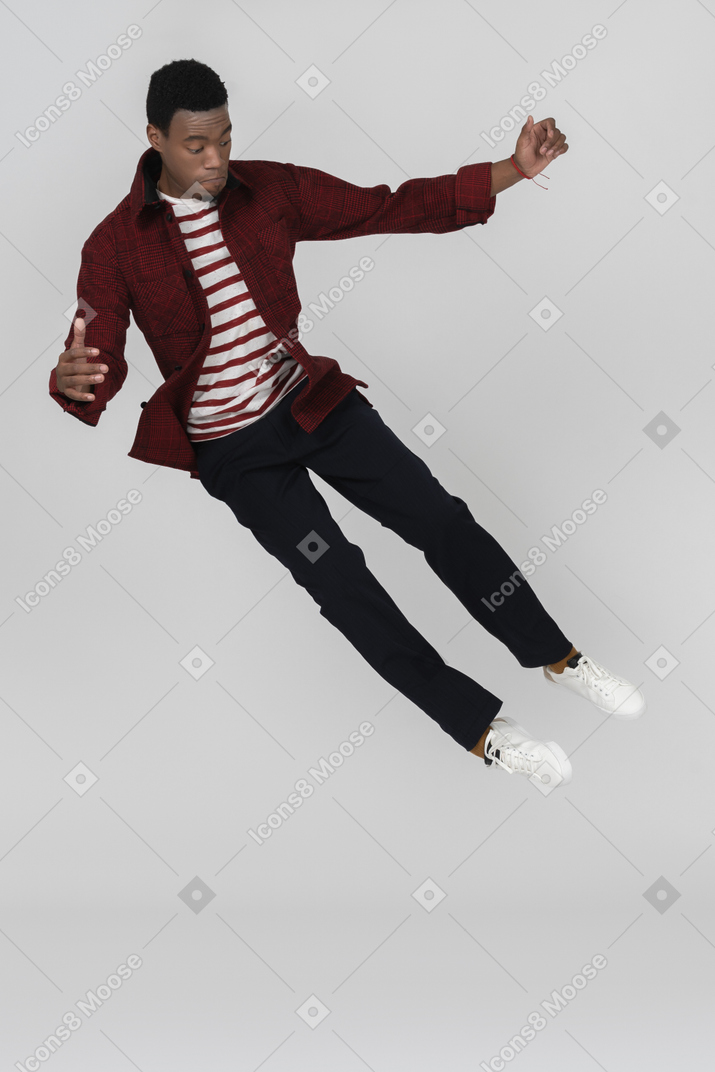Black man jumping with his legs straight