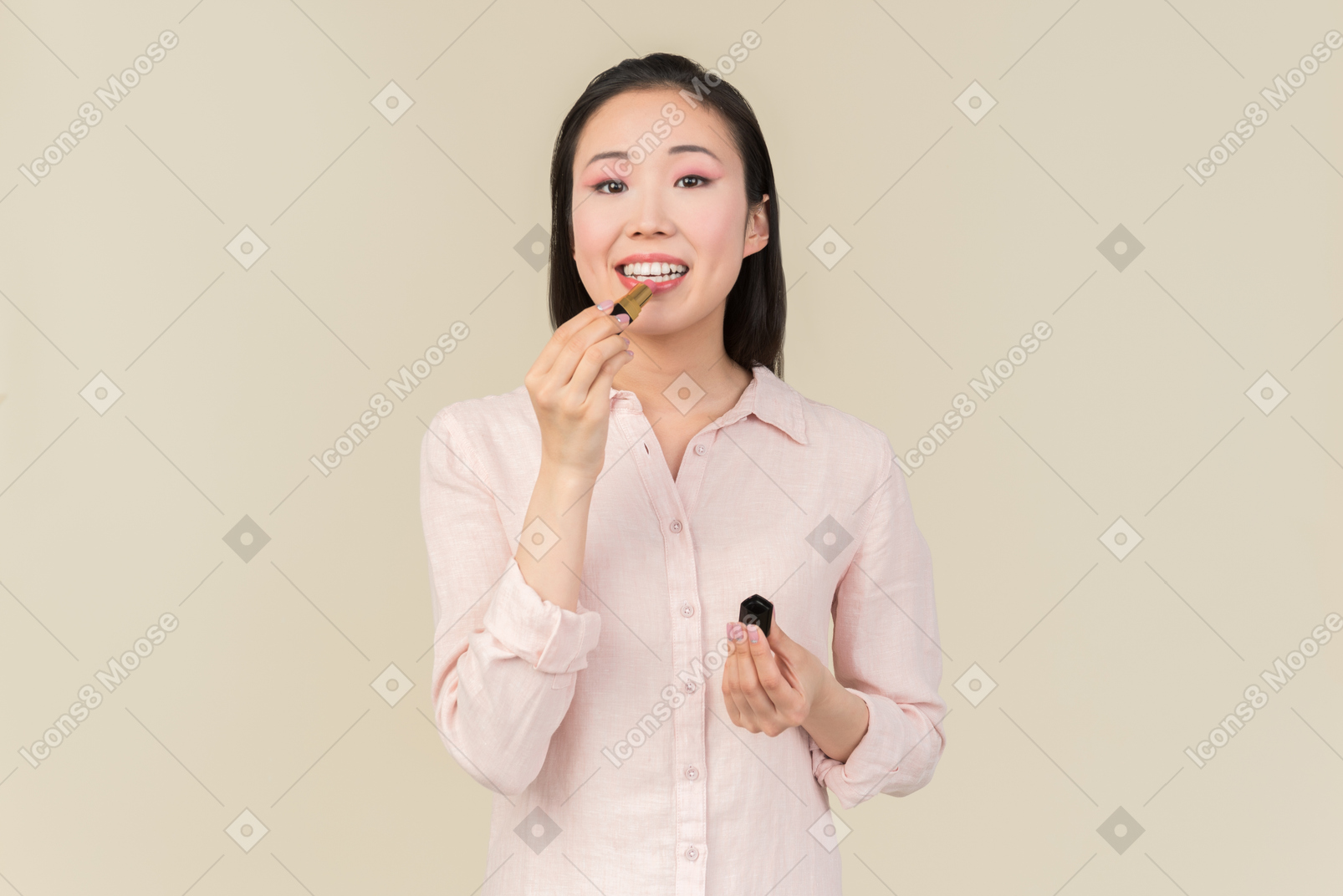 Young asian woman applying lipstick