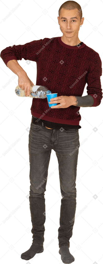 Front view of a young man in red pullover pouring some water