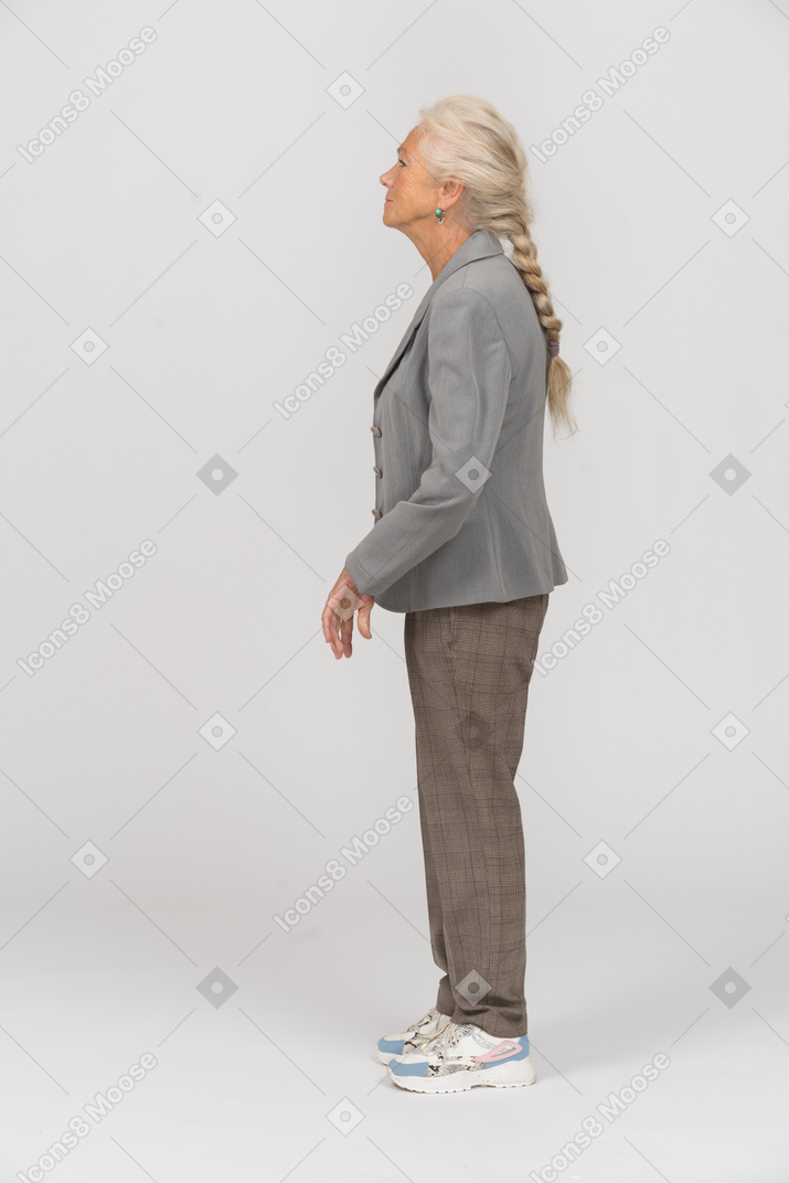 Side view of an old woman in suit posing