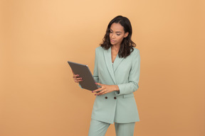 Attractive young office worker  looking at something attentively