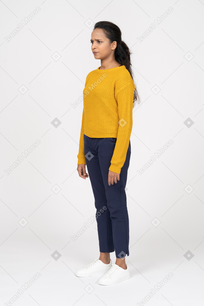 Confused young woman in casual clothes standing in profile