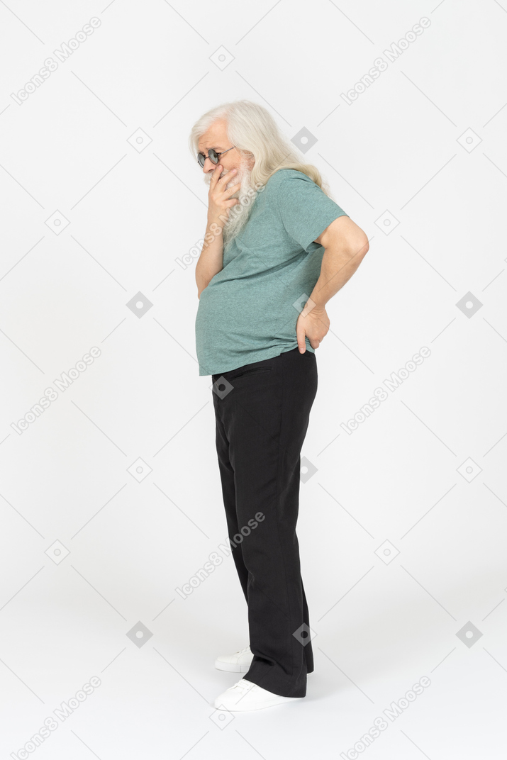 Side view of old man in sunglasses wondering